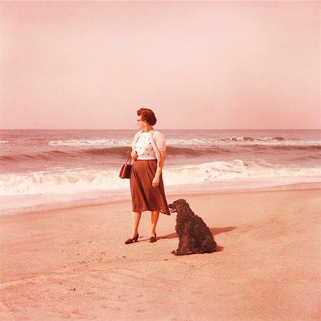 Mature woman and dog at beach Stock Photo - Premium Royalty-Free, Code: 628-02062591