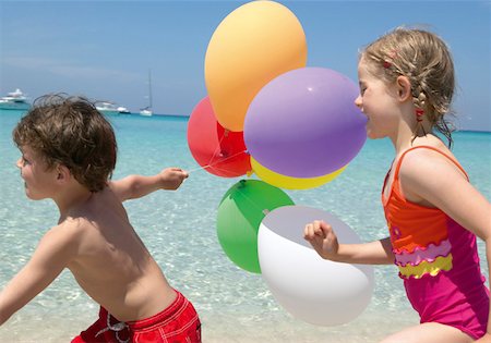 Two children with balloons at beach Stock Photo - Premium Royalty-Free, Code: 628-02062659