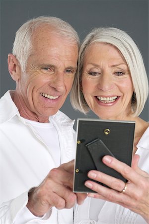 Senior couple watching a picture Stock Photo - Premium Royalty-Free, Code: 628-02228219
