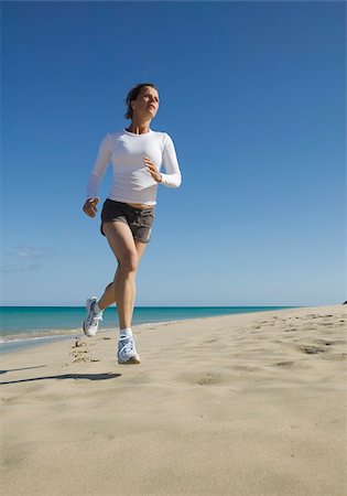 Young woman jogging at beach Stock Photo - Premium Royalty-Free, Code: 628-02615610