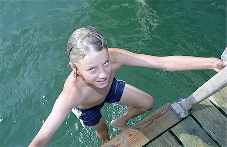 preteen swim - Blonde Boy climbing up a Ladder out of the Water - Swimming - Fun - Leisure Time - Youth Stock Photo - Premium Royalty-Free, Code: 628-02615689