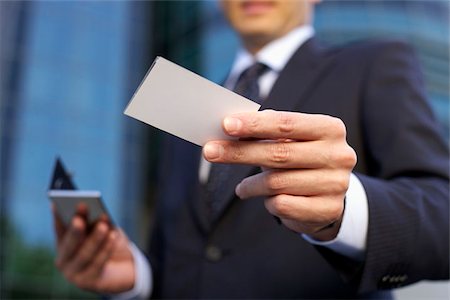 people holding cards in hand - Man holding a calling card into the camera Stock Photo - Premium Royalty-Free, Code: 628-02954084