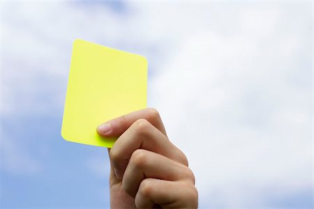 people holding cards in hand - Referee showing yellow card Stock Photo - Premium Royalty-Free, Code: 628-02954163