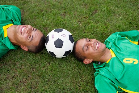 Two Brazilian soccer players lying on grass Stock Photo - Premium Royalty-Free, Code: 628-02954185