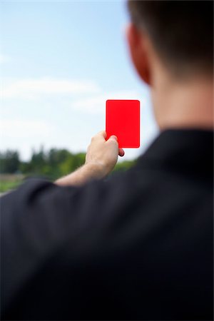 people holding cards in hand - Referee showing red card Stock Photo - Premium Royalty-Free, Code: 628-02954186