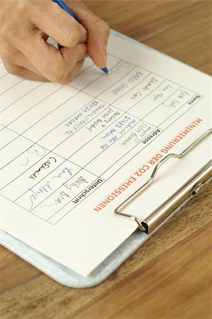 Woman signing a list for minimization of CO2 emissions Stock Photo - Premium Royalty-Free, Code: 628-02953535