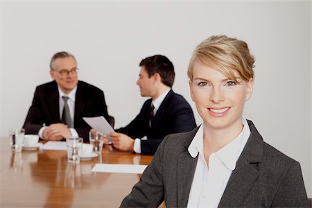 Three businesspeople in conference room, Bavaria, Germany Stock Photo - Premium Royalty-Free, Code: 628-02953610