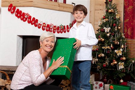 Boy receiving Christmas present from grandmother Stock Photo - Premium Royalty-Free, Code: 628-02953659