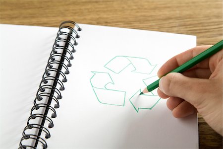 drawing pictures environment - Hand drawing recycling symbol in binder, Germany Stock Photo - Premium Royalty-Free, Code: 628-02953703