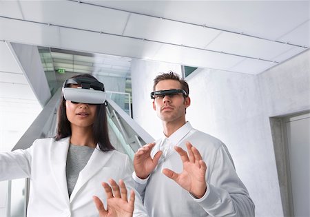 Woman and man with head-mounted displays Stock Photo - Premium Royalty-Free, Code: 628-02953814