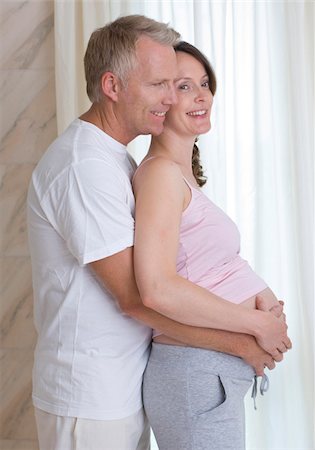 expecting - Man embracing pregnant woman Stock Photo - Premium Royalty-Free, Code: 628-03058872