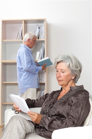 Senior couple reading at home Stock Photo - Premium Royalty-Free, Code: 628-03201161