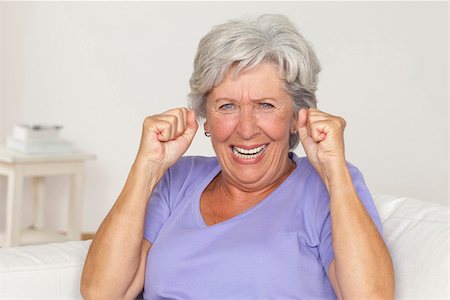 Senior woman cheering with clenched fists Stock Photo - Premium Royalty-Free, Code: 628-03201173