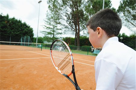 determined youth sports - Young Boy Preparing For Shot Foto de stock - Sin royalties Premium, Código: 622-05390891