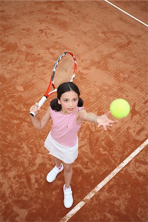 Young Girl Serve The Tennis Ball Stock Photo - Premium Royalty-Free, Code: 622-05390907