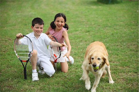 smiling lab dog - Young Boy And Girl Playing With Labrador Breed Dog Stock Photo - Premium Royalty-Free, Code: 622-05390914