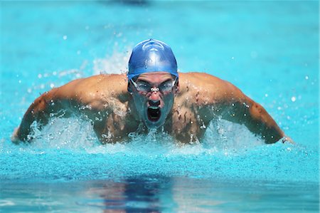 swim cap competitive - Young Man Swimming Butterfly Stock Photo - Premium Royalty-Free, Code: 622-05786871