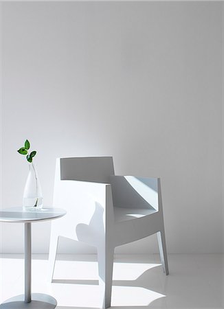 Easy Chair And Side Table In White Stock Photo - Premium Royalty-Free, Code: 622-06009470