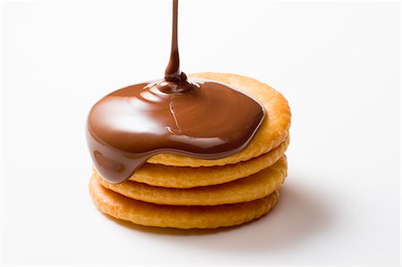 Melt Chocolate Dropping On Stack Of Biscuit Stock Photo - Premium Royalty-Free, Code: 622-06010044