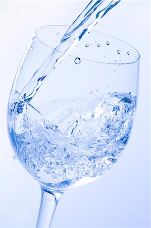 Water Pouring Into Glass with colored background Stock Photo - Premium Royalty-Free, Code: 622-06010097