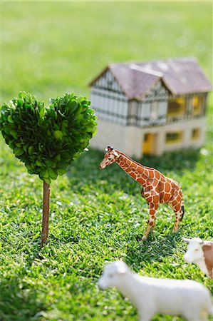 House Structure Alongside Animals And Heart Shape Tree Stock Photo - Premium Royalty-Free, Code: 622-06163864