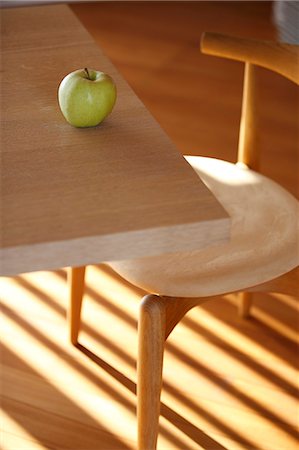 fruits in wooden table - Apple On Table Near Wooden Chair Stock Photo - Premium Royalty-Free, Code: 622-06190711