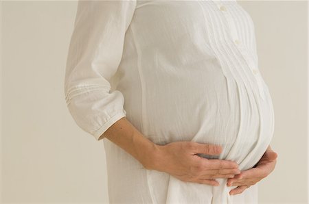 photograph of pregnant women - Belly of a pregnant woman Foto de stock - Sin royalties Premium, Código: 622-06369636
