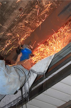 Man cutting a steel pipe Stock Photo - Premium Royalty-Free, Code: 622-06397834