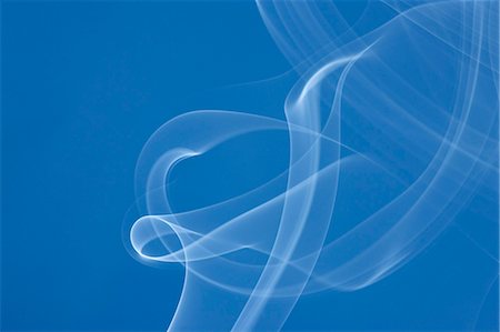 flowing - White smoke on blue background Stock Photo - Premium Royalty-Free, Code: 622-06486763