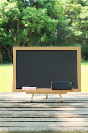 Blackboard placed on wood deck Stock Photo - Premium Royalty-Free, Code: 622-06809718