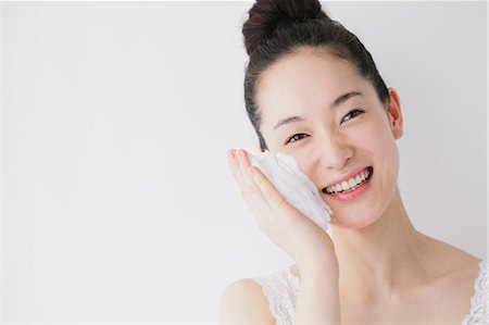 Young woman putting face-wash foam Stock Photo - Premium Royalty-Free, Code: 622-06964275