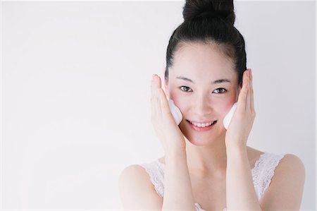 Young woman putting face-wash foam Stock Photo - Premium Royalty-Free, Code: 622-06964272