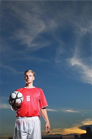 soccer player holding ball - Soccer Player Standing With Ball Photographie de stock - Premium Libres de Droits, Code: 622-07736095