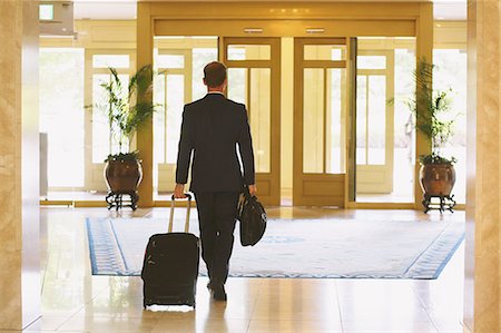 Businessman leaving hotel Stock Photo - Premium Royalty-Free, Code: 622-08007243