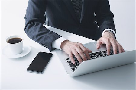 Japanese businessman working with laptop Stock Photo - Premium Royalty-Free, Code: 622-08122885