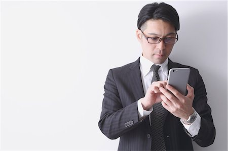 simsearch:622-08519684,k - Japanese businessman working with large display smartphone Stock Photo - Premium Royalty-Free, Code: 622-08122893