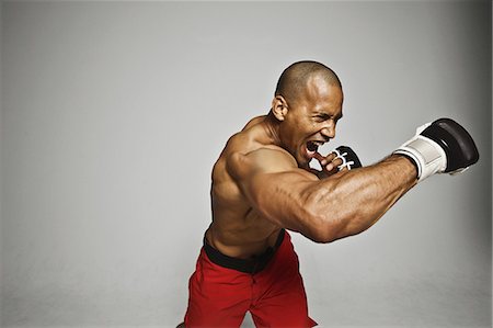 Bald male athlete in a fighting pose Stock Photo - Premium Royalty-Free, Code: 622-08123197