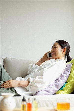 simsearch:622-08519691,k - Woman using a Smartphone on the sofa Stock Photo - Premium Royalty-Free, Code: 622-08138929