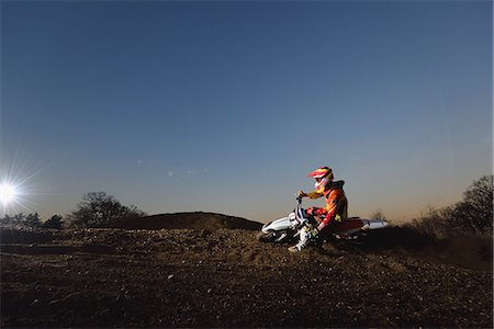 Motocross biker on dirt track Stock Photo - Premium Royalty-Free, Code: 622-08355462