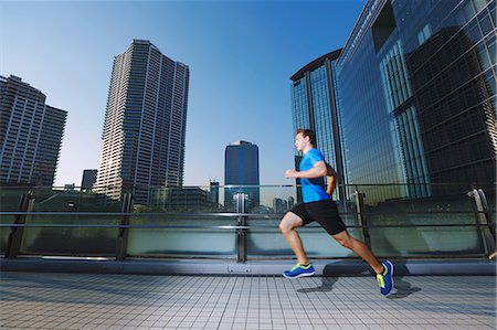 running a marathon - Young Caucasian man running in metropolitan area Stock Photo - Premium Royalty-Free, Code: 622-08355638