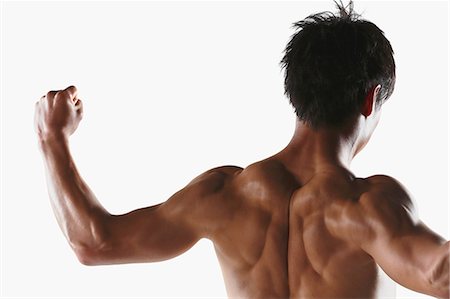 Japanese male athlete showing off muscles Stock Photo - Premium Royalty-Free, Code: 622-08355737