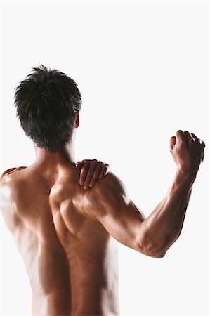 Japanese male athlete showing off muscles Stock Photo - Premium Royalty-Free, Code: 622-08355739