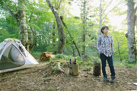 Young Japanese woman at a camp site Stock Photo - Premium Royalty-Free, Code: 622-08519656