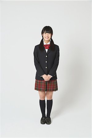 plaid skirt - Japanese High-school student in uniform against white background Stock Photo - Premium Royalty-Free, Code: 622-08578940