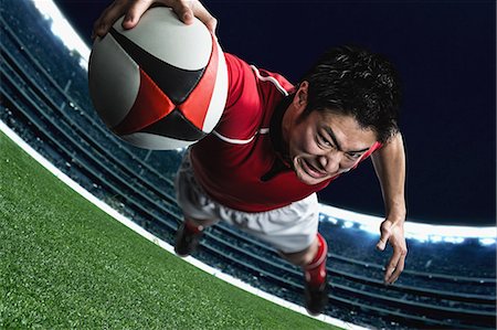 diving (not water) - Portrait of Japanese rugby player diving to score a try Stock Photo - Premium Royalty-Free, Code: 622-08657608