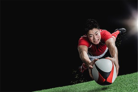 diving (not water) - Portrait of Japanese rugby player diving to score a try Stock Photo - Premium Royalty-Free, Code: 622-08657616