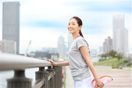 Attractive Japanese woman training by a river downtown Tokyo, Japan Stock Photo - Premium Royalty-Free, Code: 622-08839860