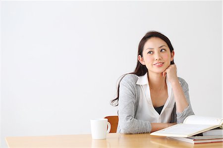 simsearch:614-02985269,k - Attractive Japanese woman sitting at a table in a airy room Stock Photo - Premium Royalty-Free, Code: 622-08839879