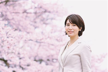 simsearch:862-03712492,k - Japanese woman with cherry blossoms in a city park Stock Photo - Premium Royalty-Free, Code: 622-08893831