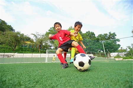 sky and ground - Japanese kids playing soccer Stock Photo - Premium Royalty-Free, Code: 622-08893955